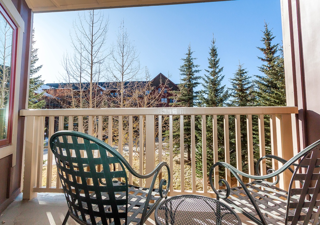 Step onto your private balcony and breathe in the crisp mountain air while enjoying peaceful forest views from your outdoor chairs.