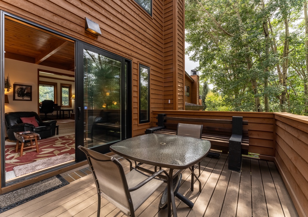 Your private deck invites you to dine al fresco surrounded by towering trees, with seamless indoor-outdoor flow perfect for morning coffee or evening meals.