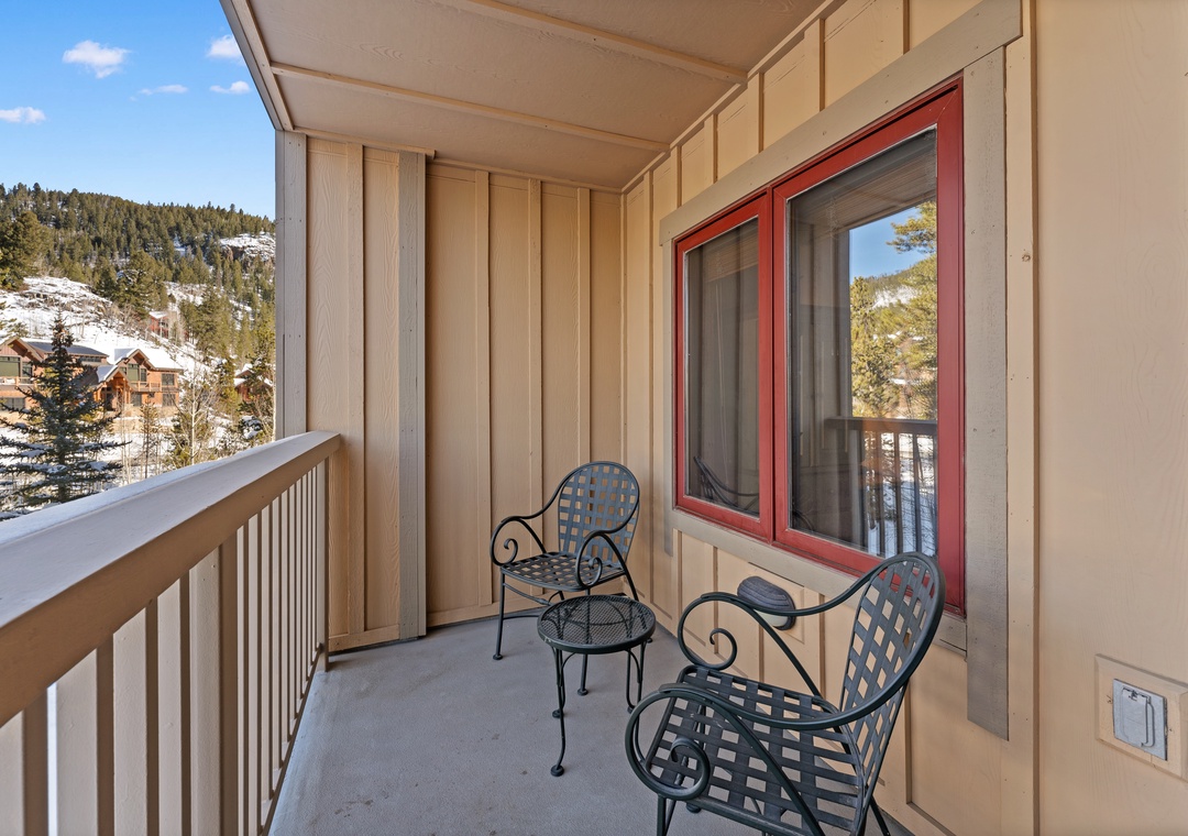 Step onto your private balcony where cozy seating awaits you to savor mountain views and fresh alpine air during peaceful moments.
