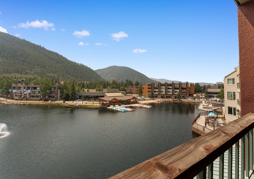 A lakeside resort community nestled in the surrounding mountain landscape, with boat docks and waterfront access nearby.