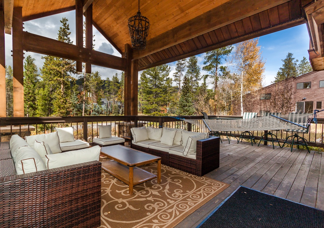 Unwind on your private covered deck with cozy seating and forest views, perfect for morning coffee or evening relaxation.