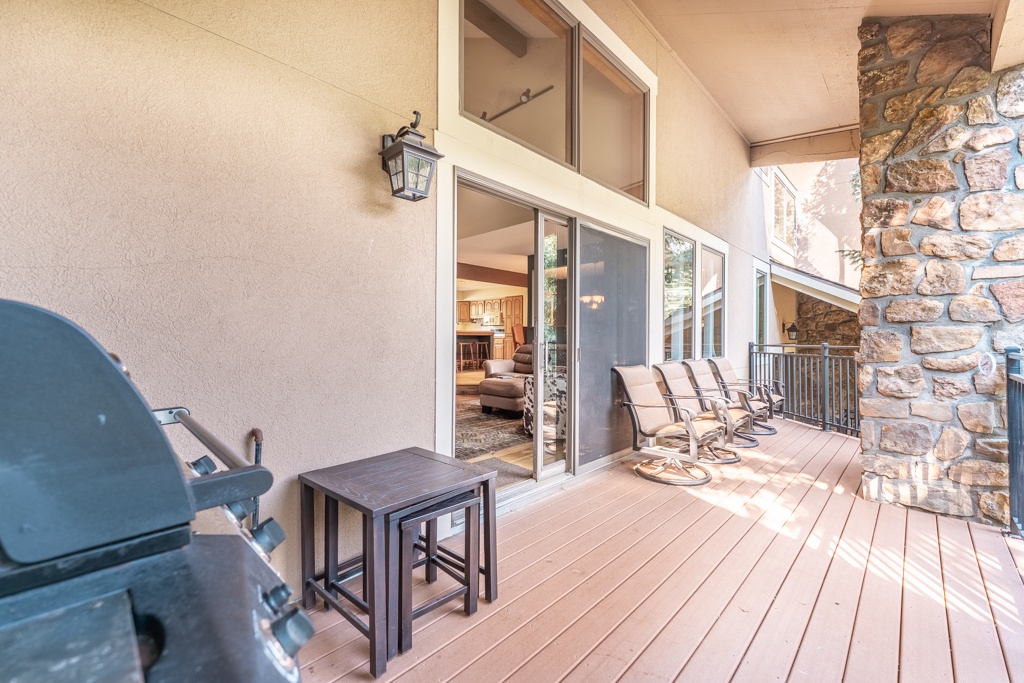 Step onto your private deck with a BBQ grill, cozy seating, and rustic stone fireplace—perfect for morning coffee or evening gatherings under the open sky.