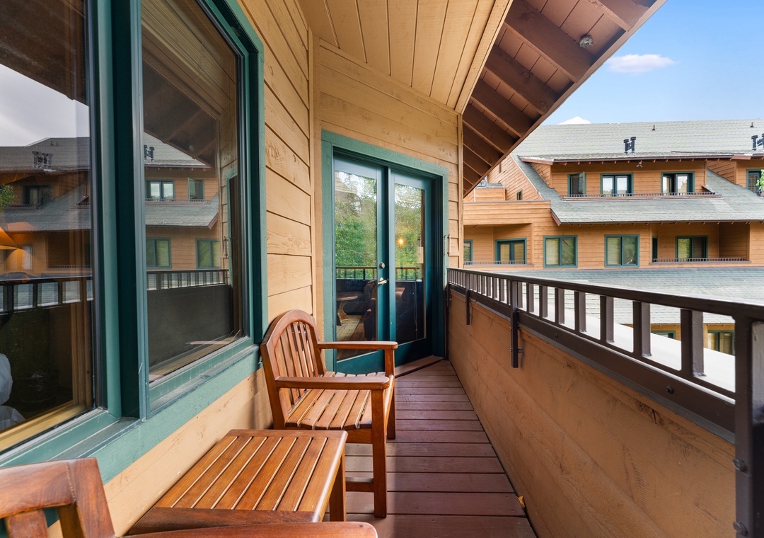 Step onto your private wooden balcony where comfortable teak furniture awaits your morning coffee moments overlooking charming alpine architecture.