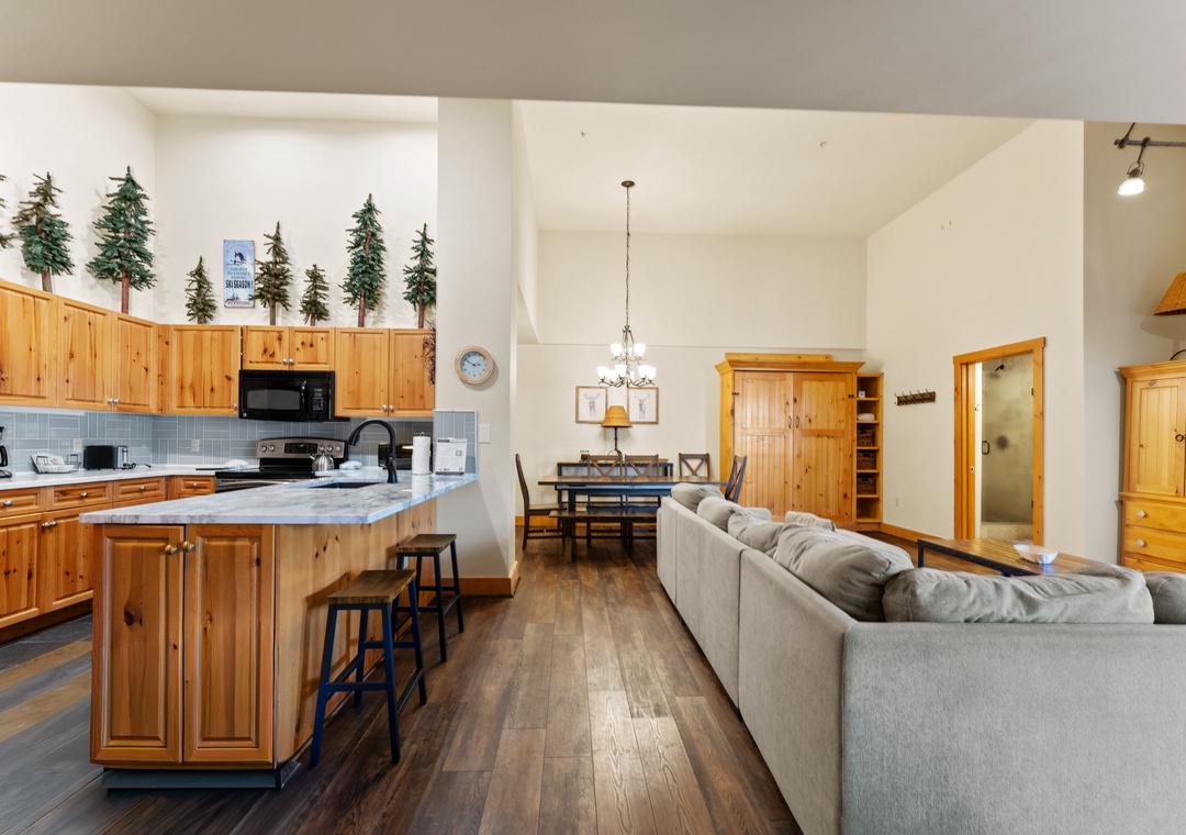Step into your cozy mountain retreat where rustic charm meets comfort—featuring a fully equipped kitchen and open living space.