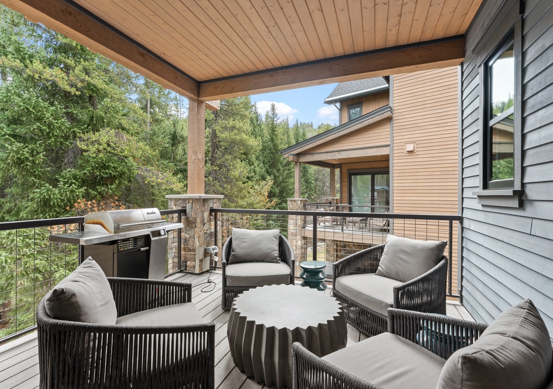 Your private covered deck overlooks lush forest, with plush seating, a BBQ, and mountain air perfect for morning coffee or evening relaxation.