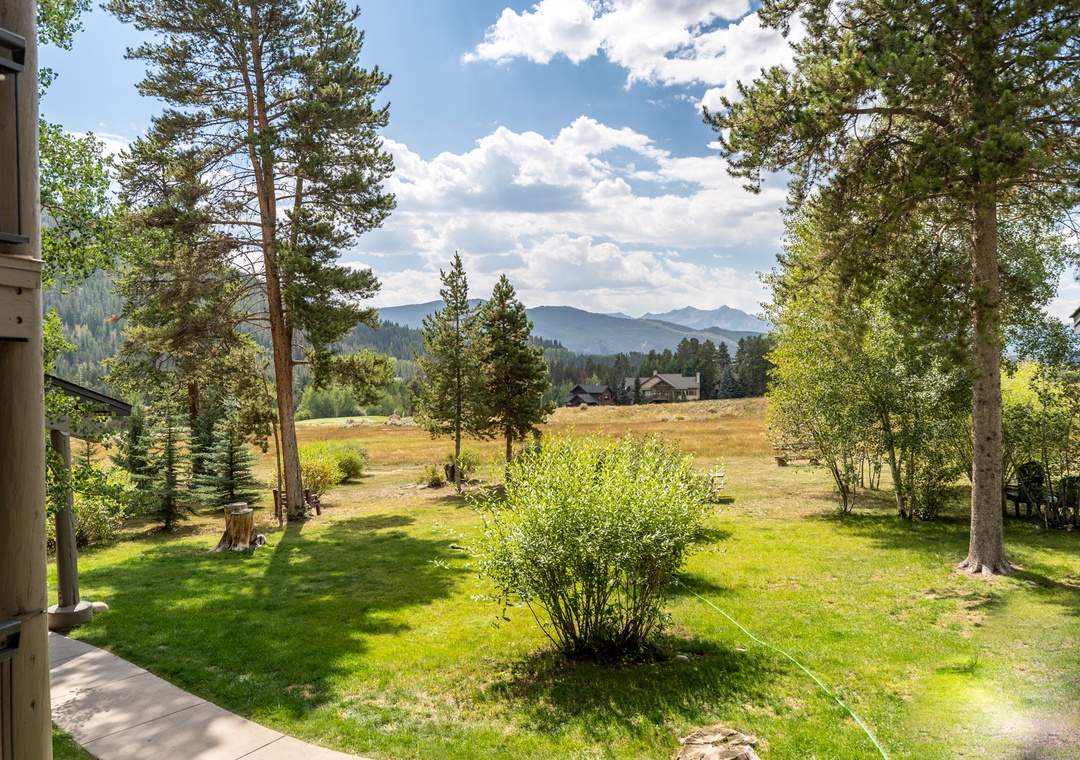 Breathtaking mountain views stretch across rolling meadows from your peaceful retreat, where towering pines frame the majestic landscape.