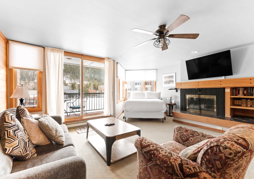 Unwind in your spacious studio with cozy fireplace, mountain views, and comfortable seating perfect for après-ski relaxation.