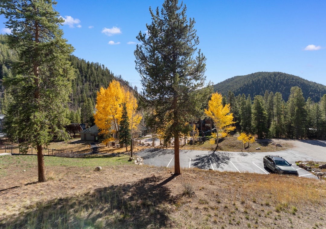 Mountain retreat surrounded by golden autumn aspens and towering evergreens, with convenient parking and peaceful natural setting.
