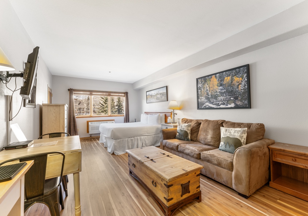 Unwind in your cozy mountain retreat with plush seating, rustic charm, and peaceful views through large windows.