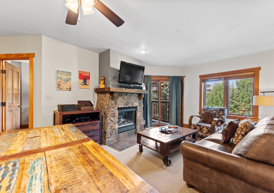 Cozy up by your stone fireplace with leather seating, rustic touches, and mountain views through large windows.