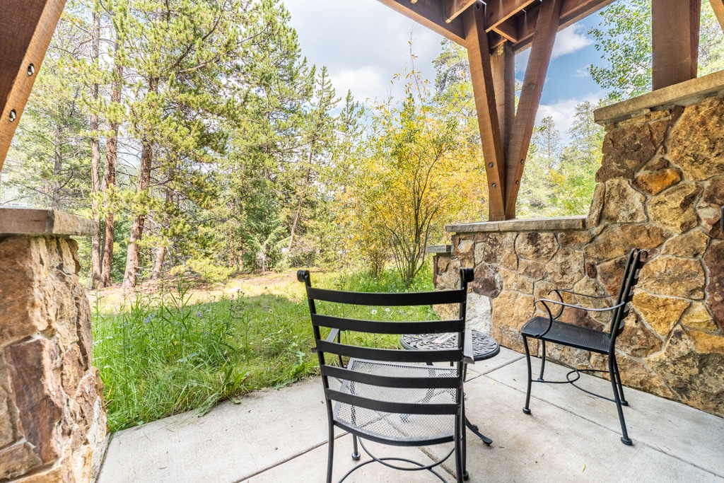 Relax in your private outdoor seating area surrounded by lush greenery and peaceful natural scenery.