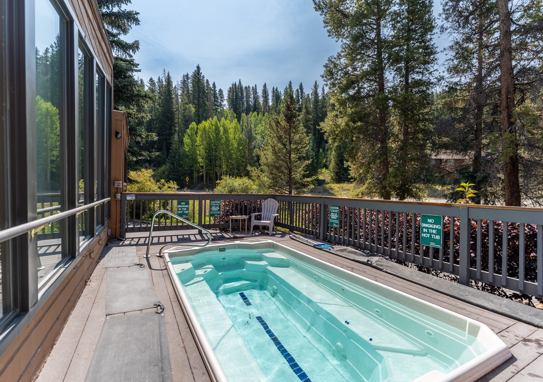 Soak in your private hot tub while gazing at towering evergreens and peaceful mountain views from your spacious deck.