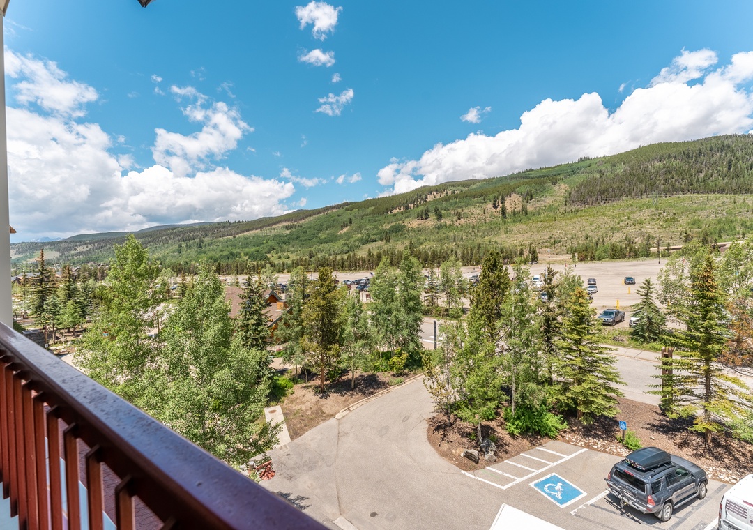 Sweeping mountain and forest views stretch endlessly from this elevated balcony, showcasing the natural beauty surrounding the property.