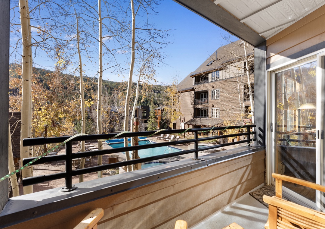Your private balcony overlooks the swimming pool and frames stunning mountain and forest views—perfect for morning coffee or unwinding after a day of adventure.