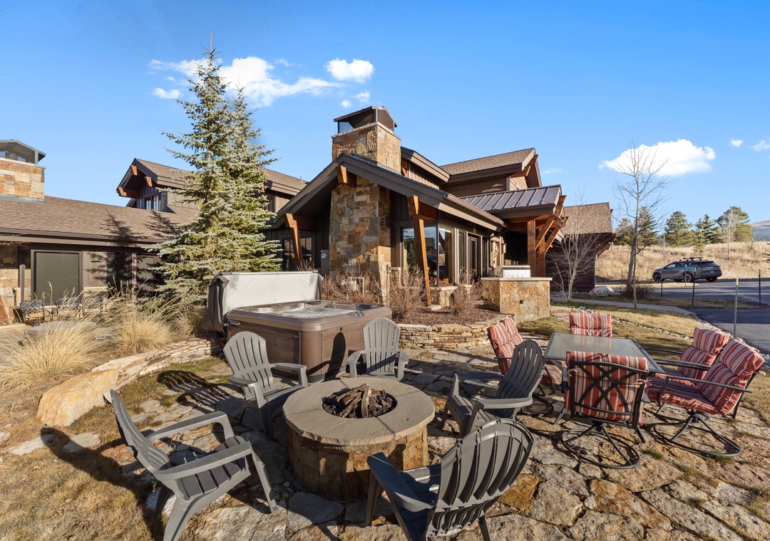 Modern mountain lodge exterior featuring stone and timber construction, surrounded by natural landscaping in a pristine wilderness setting.