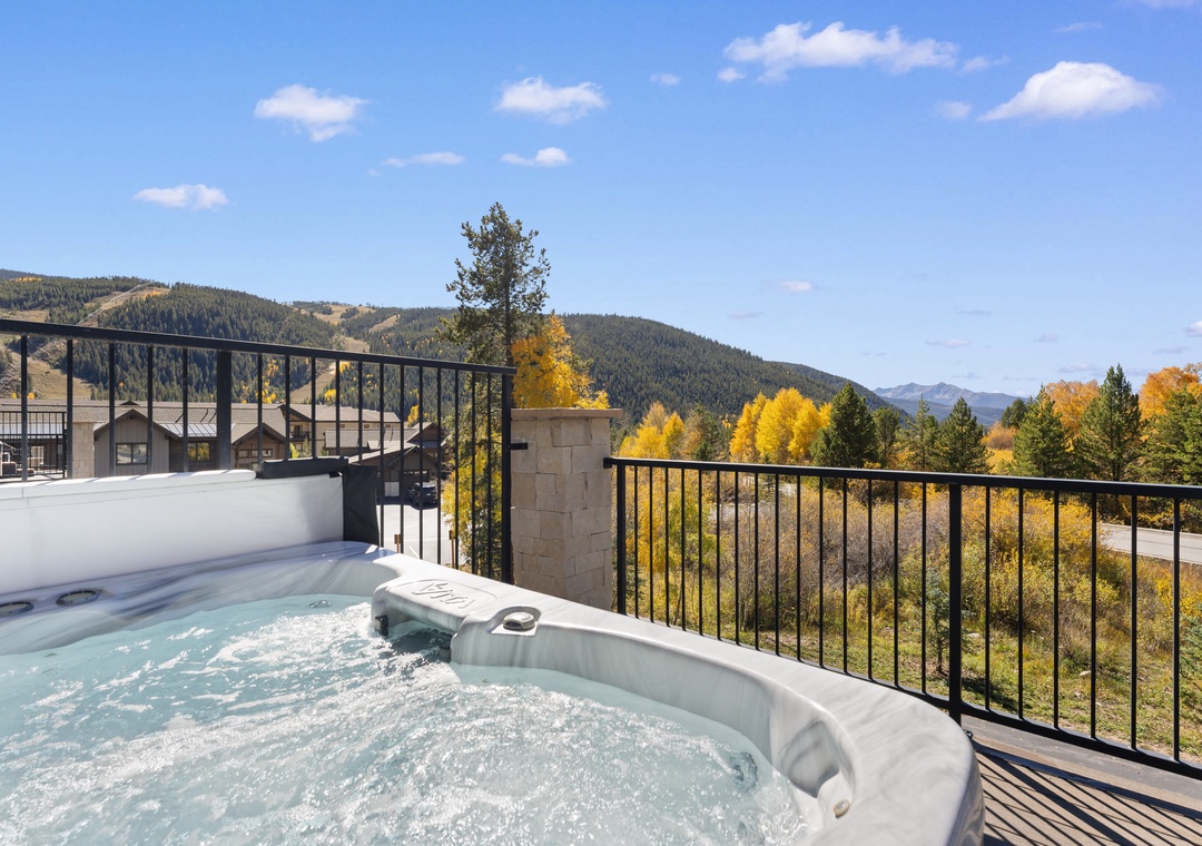 Soak in your private hot tub while gazing at vibrant autumn foliage and mountain peaks stretching across the horizon.
