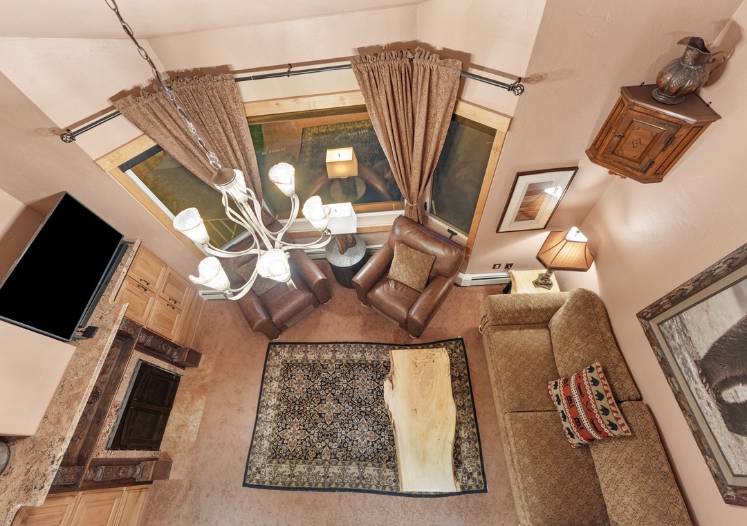 Sink into plush leather seating by your elegant fireplace, where warm lighting and rustic charm create the perfect cozy retreat.