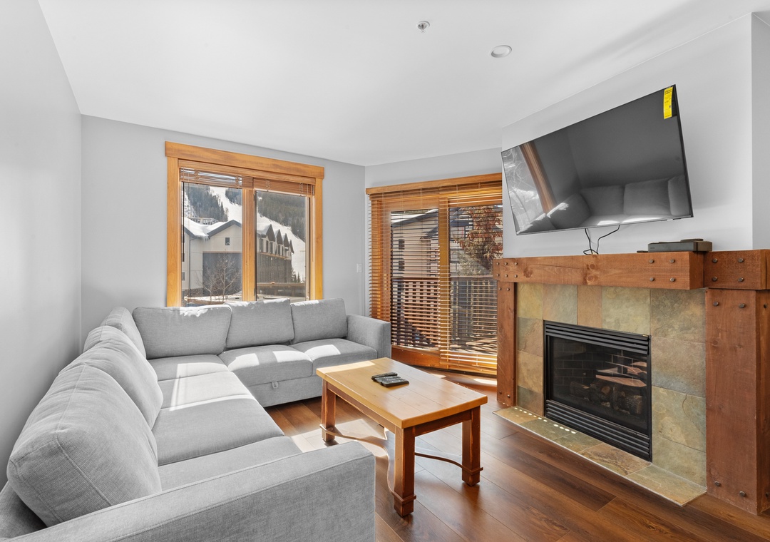 Relax on your plush sectional sofa as natural light pours through the windows. Cozy up by the fireplace with mountain views just outside, or unwind with your favorite show on the flat-screen TV.