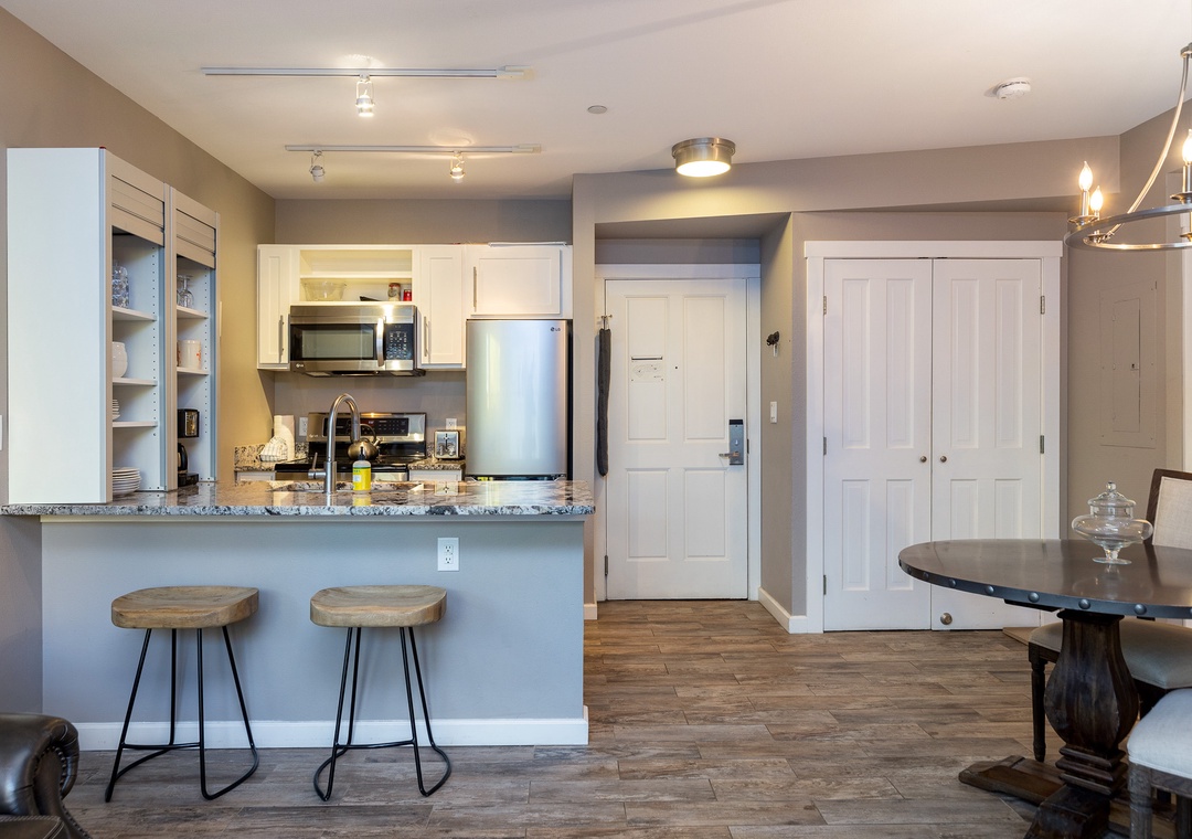 Your modern kitchen opens to the dining area, where granite countertops and bar seating create the perfect space for morning coffee or evening conversations.