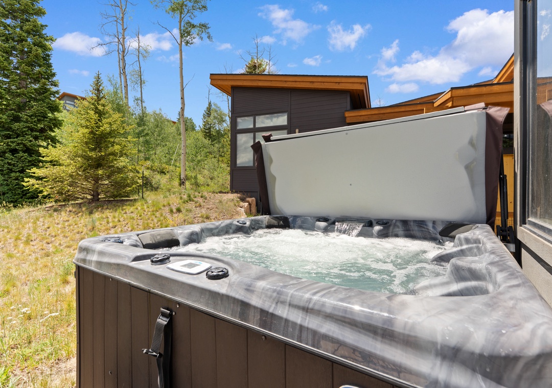 Soak your muscles in this private hot tub surrounded by towering pines and mountain fresh air—your perfect mountain retreat.