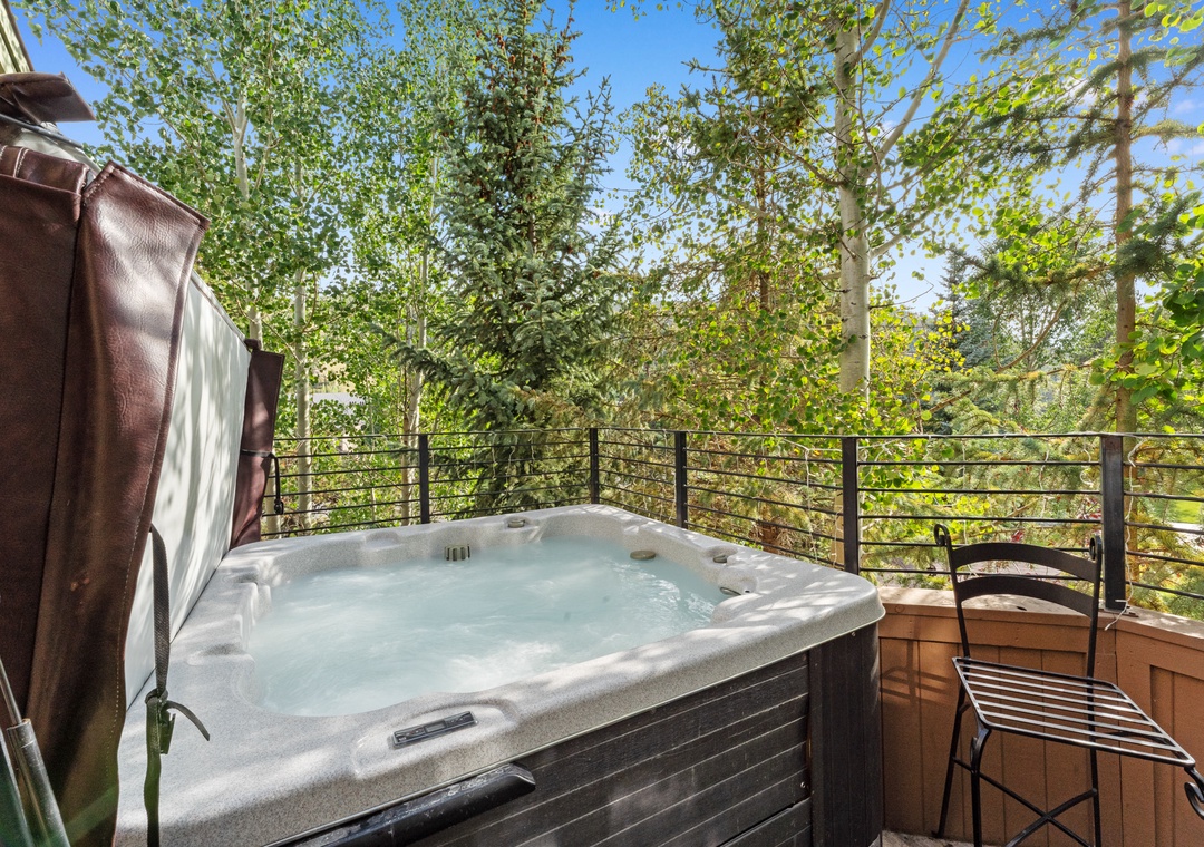 Soak in your private hot tub surrounded by towering trees, where warm bubbles meet cool forest air for pure relaxation.