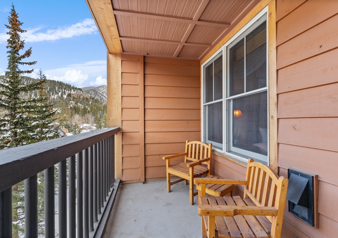 Step onto your private balcony where wooden chairs await your morning coffee moments, framed by stunning mountain views.