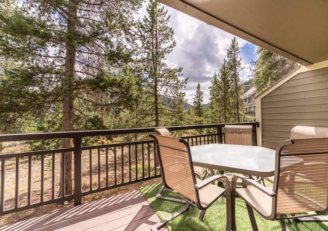Step onto your private balcony and breathe in the fresh mountain air while enjoying coffee at your outdoor table surrounded by towering pines.