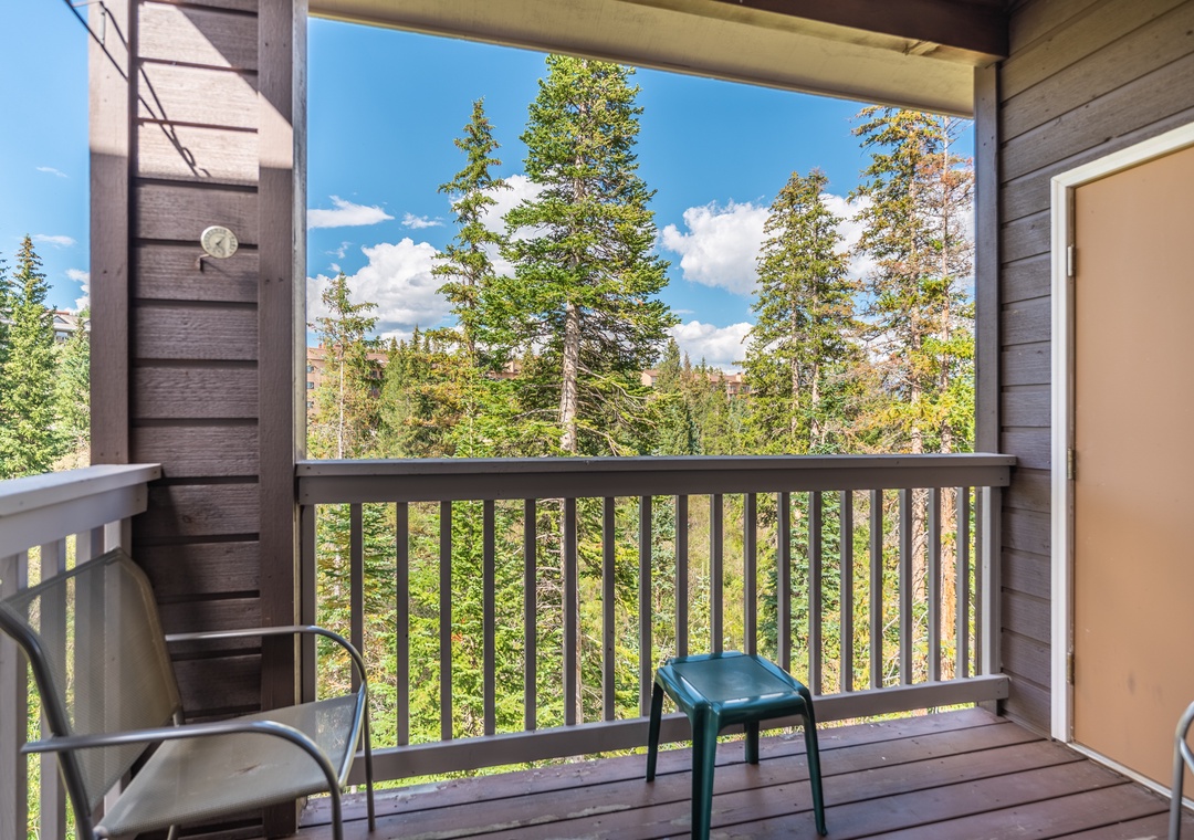 Your private covered balcony frames serene forest views and mountain scenery—perfect for morning coffee or watching clouds drift by on warm afternoons.