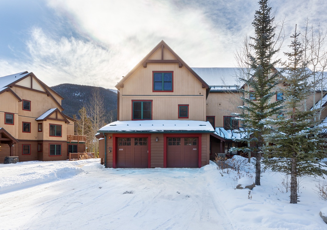 Mountain village retreat with ski-in access and private garage in pristine winter setting.