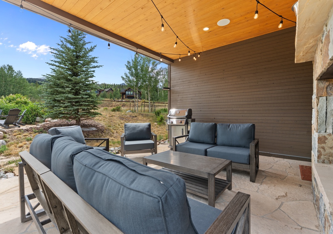 Relax in your own covered outdoor lounge, complete with plush seating, a grill for al fresco dinners, and warm string lights overhead—your perfect mountain retreat under the sky.