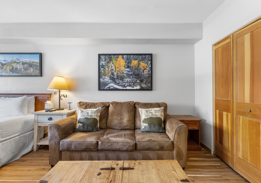 Sink into the plush leather sofa and admire mountain art while warm wood tones create your perfect alpine retreat.