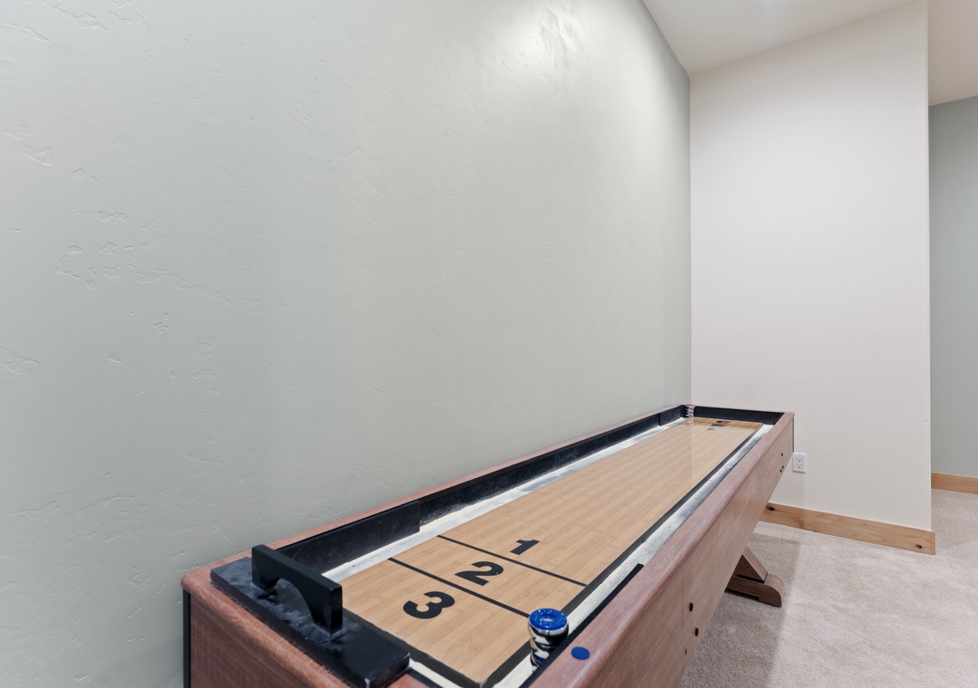 Challenge friends to a friendly match on your private shuffleboard table—a sleek space where laughter and competition meet.