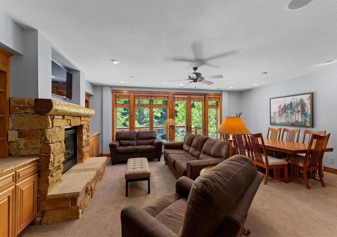 Relax in your spacious living area with cozy leather seating, a warming stone fireplace, and dining space for memorable meals together.
