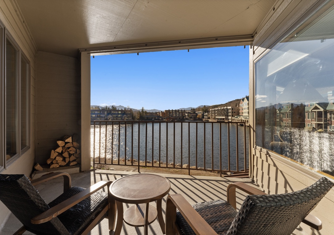 Relax on your private lakefront balcony with wicker seating and stunning water views stretching across the sparkling lake.