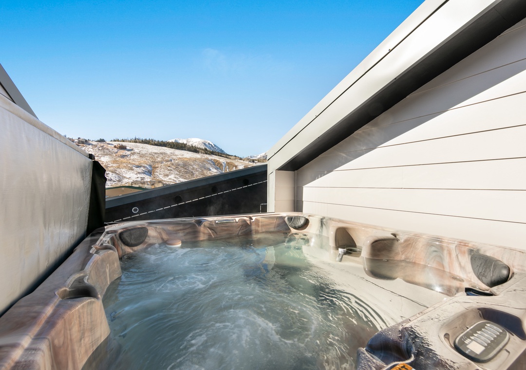 Soak in bubbling warmth while gazing at snow-capped peaks from your private rooftop hot tub oasis.
