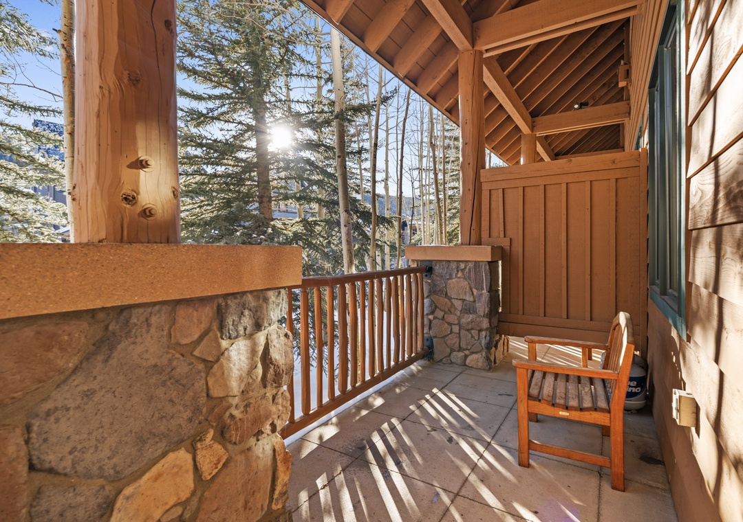 Your private mountain retreat awaits on this sun-dappled balcony, where forest views and rustic charm create the perfect escape.