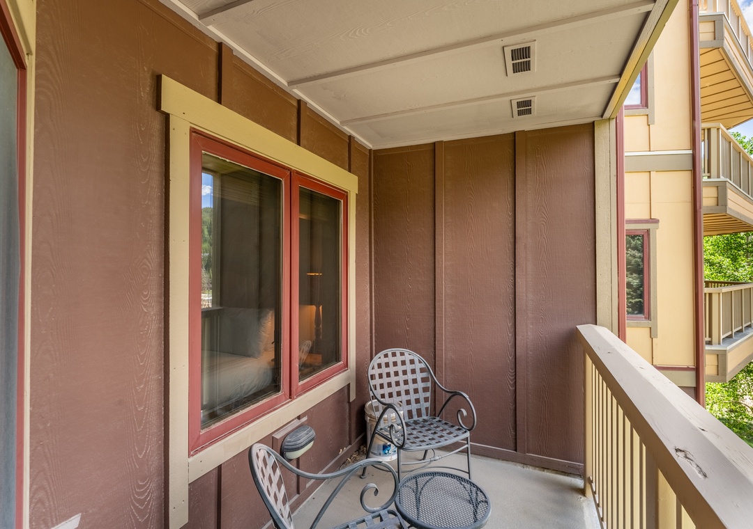 Step out onto your private balcony where morning coffee tastes even better in the fresh air, with comfortable seating overlooking the treetops.