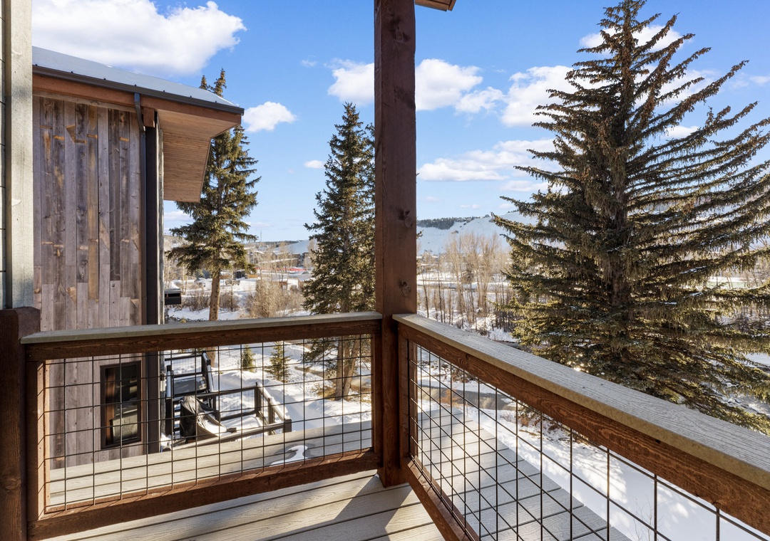 Step onto your private balcony and breathe in the crisp mountain air while taking in stunning winter views through towering evergreens.