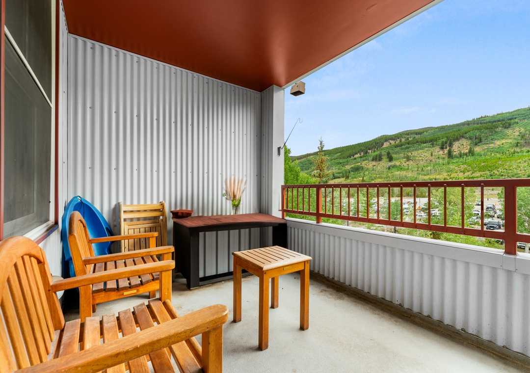 Relax on your private balcony with mountain views, wooden furniture, and peaceful countryside surroundings for the perfect getaway.