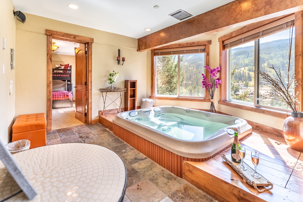 Soak in your private hot tub while gazing at stunning mountain views through panoramic windows.