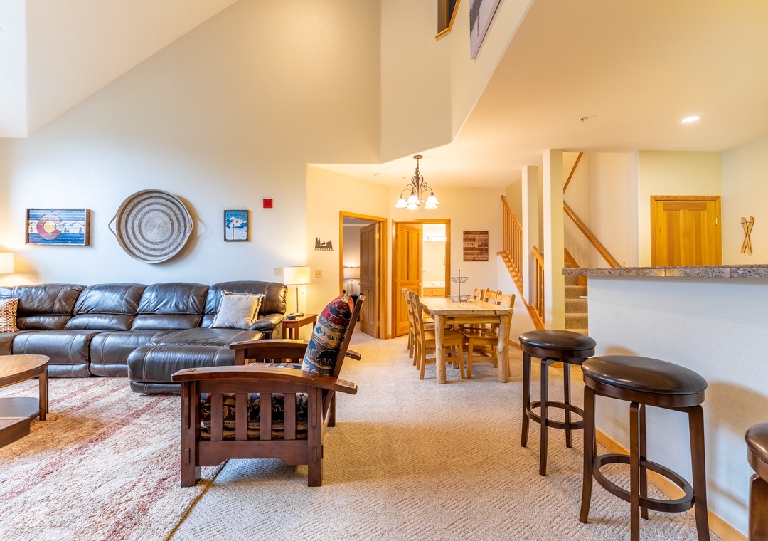 Unwind in your spacious living area featuring leather seating, mountain lodge charm, and an open layout perfect for gathering.