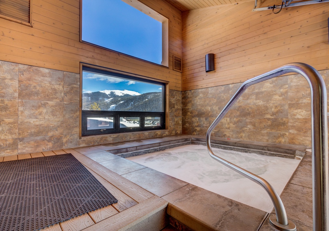Soak in warm waters while gazing at snow-capped mountain views through panoramic windows in this stunning indoor spa.