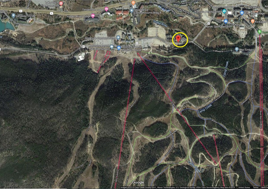 Aerial view showing the property's location within the scenic surrounding area and winding mountain roads.