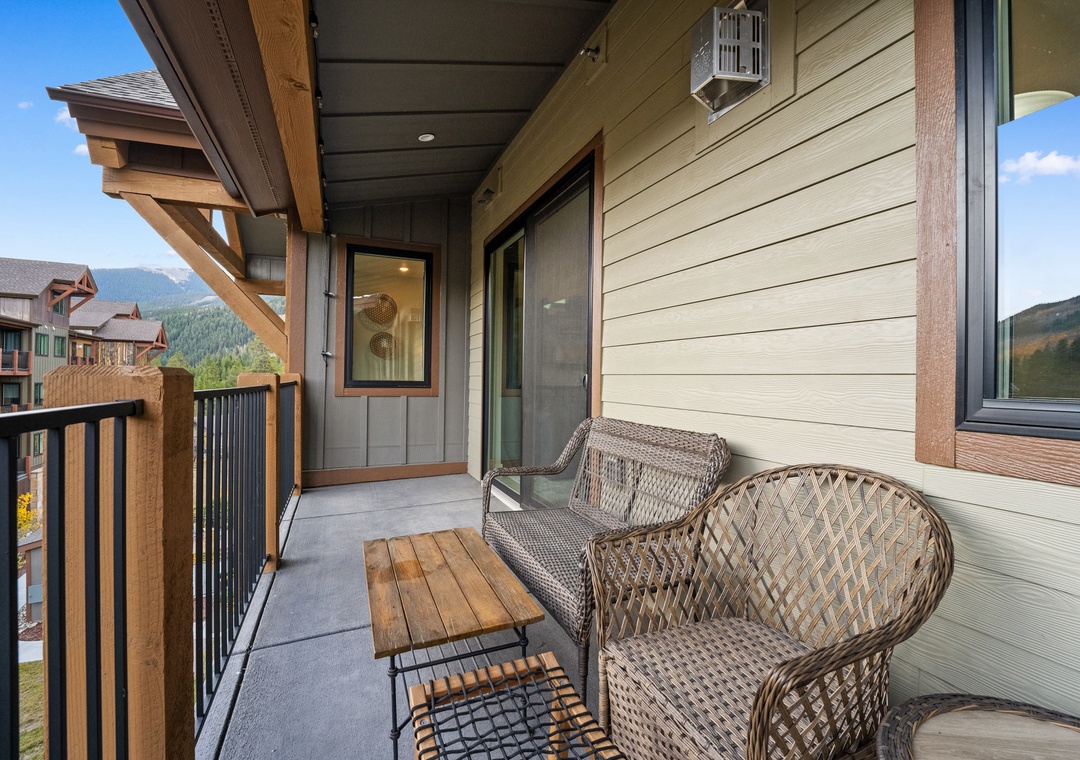 Unwind on your private balcony with wicker seating and mountain views, perfect for morning coffee or evening relaxation.