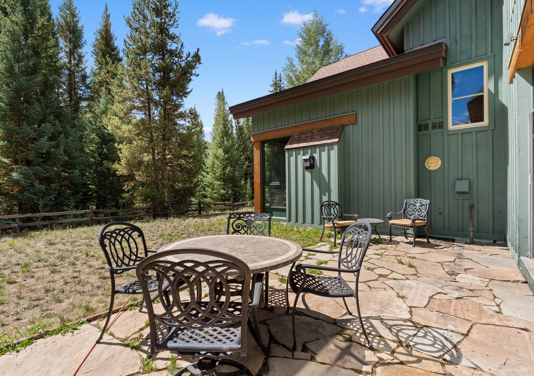 A charming mountain retreat surrounded by towering pines, offering a peaceful escape into nature. The cozy exterior and private patio create an ideal setting for your alpine getaway.