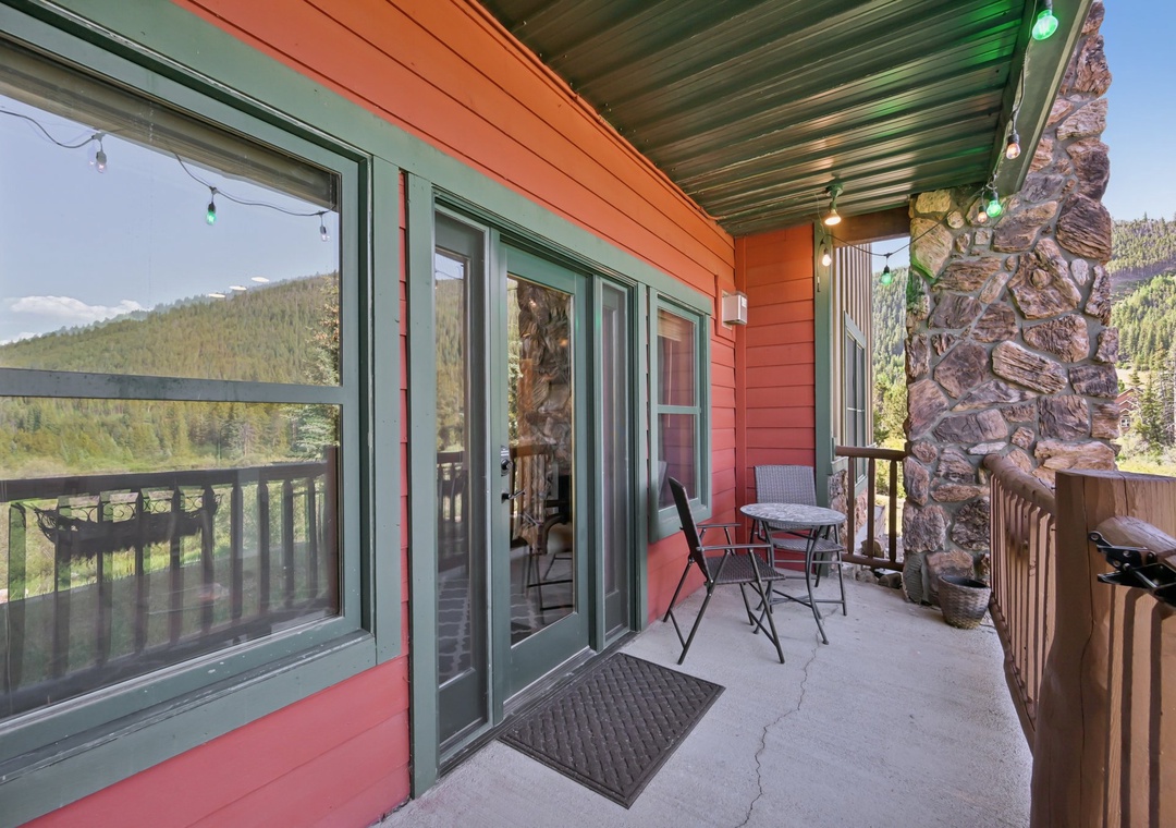 Sip your morning coffee on this mountain-view balcony, where string lights create magical evenings under the covered terrace.