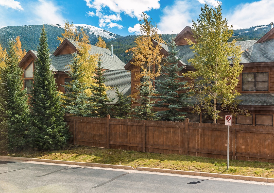 Mountain townhomes nestled among golden aspens with snow-capped peaks creating a stunning alpine backdrop for your stay.