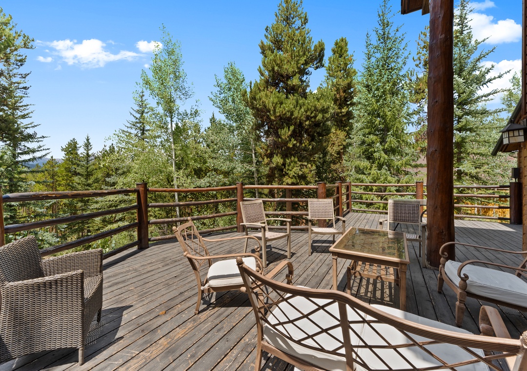 Unwind on your private deck with comfortable seating and stunning forest views stretching to the horizon.