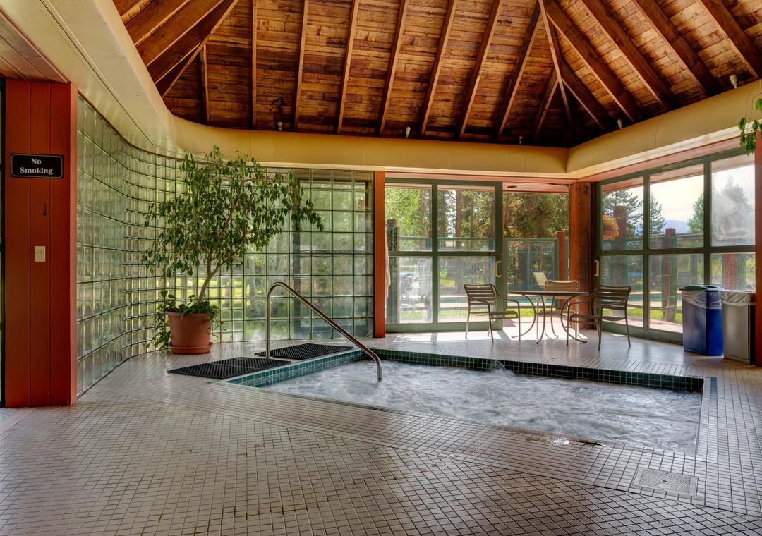 Soak away your stress in the bubbling hot tub beneath soaring wooden beams and glass walls.