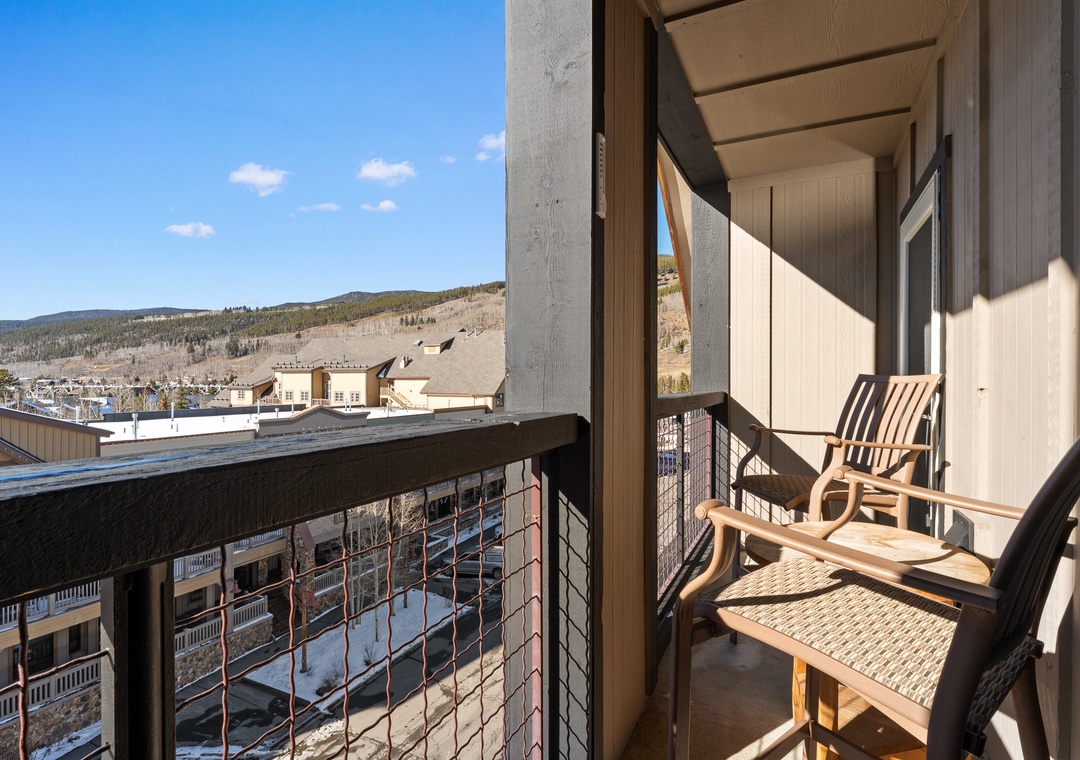 Relax on your private mountain-view balcony with comfortable seating, where morning coffee feels extra special against the stunning alpine backdrop.
